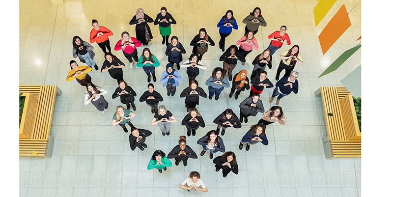 Anatomy & Neuroscience women stand together to strike the 'Inspires inclusion' heart shape pose for International Women's Day on March 8th 2024.