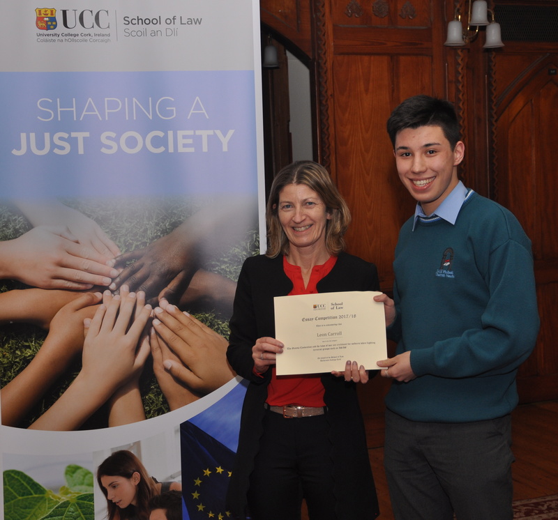 Leon Carroll being presented with a certificate by Professor Ursula Kilkelly