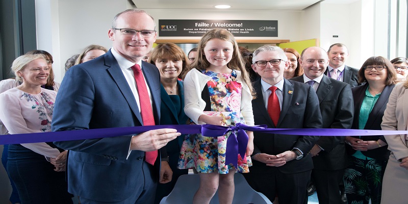 Mr Simon Coveney TD cutting ribbon with Leah Forde at opening of Paediatric Academic Unit