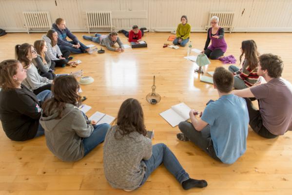 Theatre students in a circle learning