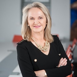 Helen Whelton, Head of College of Medicine and Health at UCC, pictured facing forward and smiling