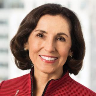 A headshot of a woman in a red blazer