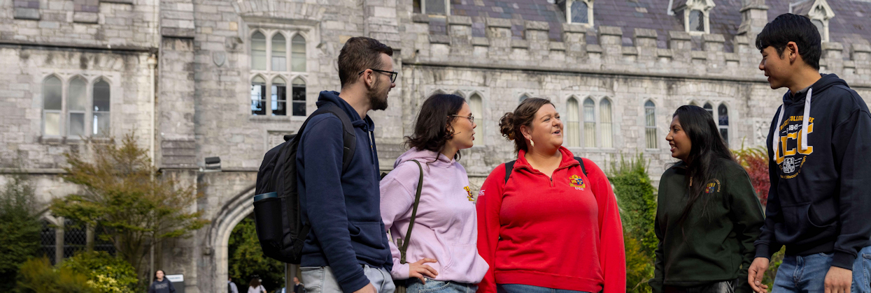 Two students walking in the main quadrangle at University College Cork