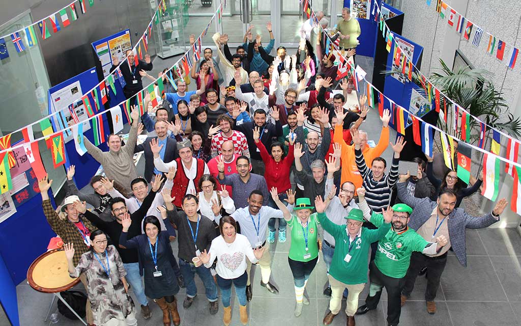 Colleagues from all over the world gather in the foyer of the Tyndall National Institute to celebrate cultural diversity