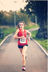 Female athlete running towards the camera