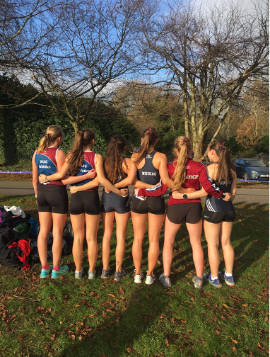 Group of female athletes facing away from camera