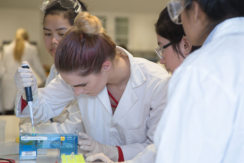 Cora Steemers, 4th year Biochemistry student, demonstrates to secondary school students from Christ King Secondary School at the DNA workshop held in the School of Biochemistry, UCC