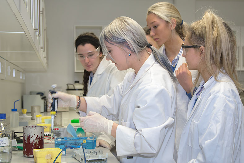 Erika Vasiliauskaite, 4th year Biochemistry student, demonstrates to secondary school students from Christ King Secondary School at the DNA workshop held in the School of Biochemistry, UCC