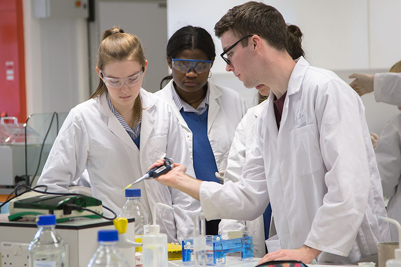 Peter Townsend, 4th year Biochemistry student, demonstrates to secondary school students from Christ King Secondary School at the DNA workshop held in the School of Biochemistry, UCC