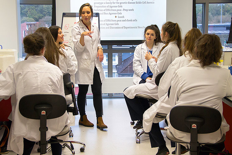 Beth Butler (4th Year Biochemistry) talking to students from Christ King Girls’ Secondary School  about the DNA extraction experiment at the DNA workshop