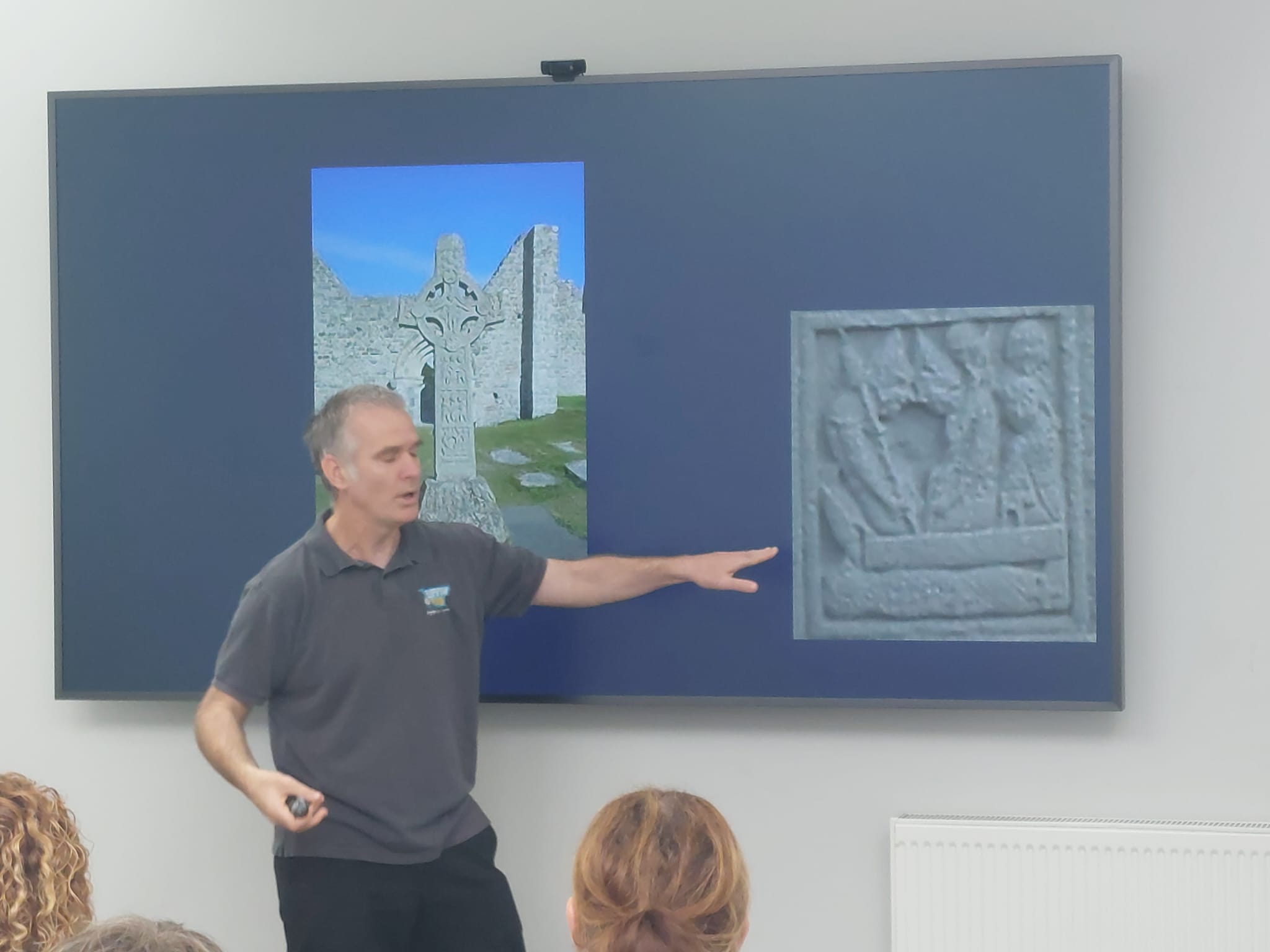 Cormac Ryan pointing to a presentation displaying a celtic cross Cormac Ryan pointing to a presentation displaying a celtic cross