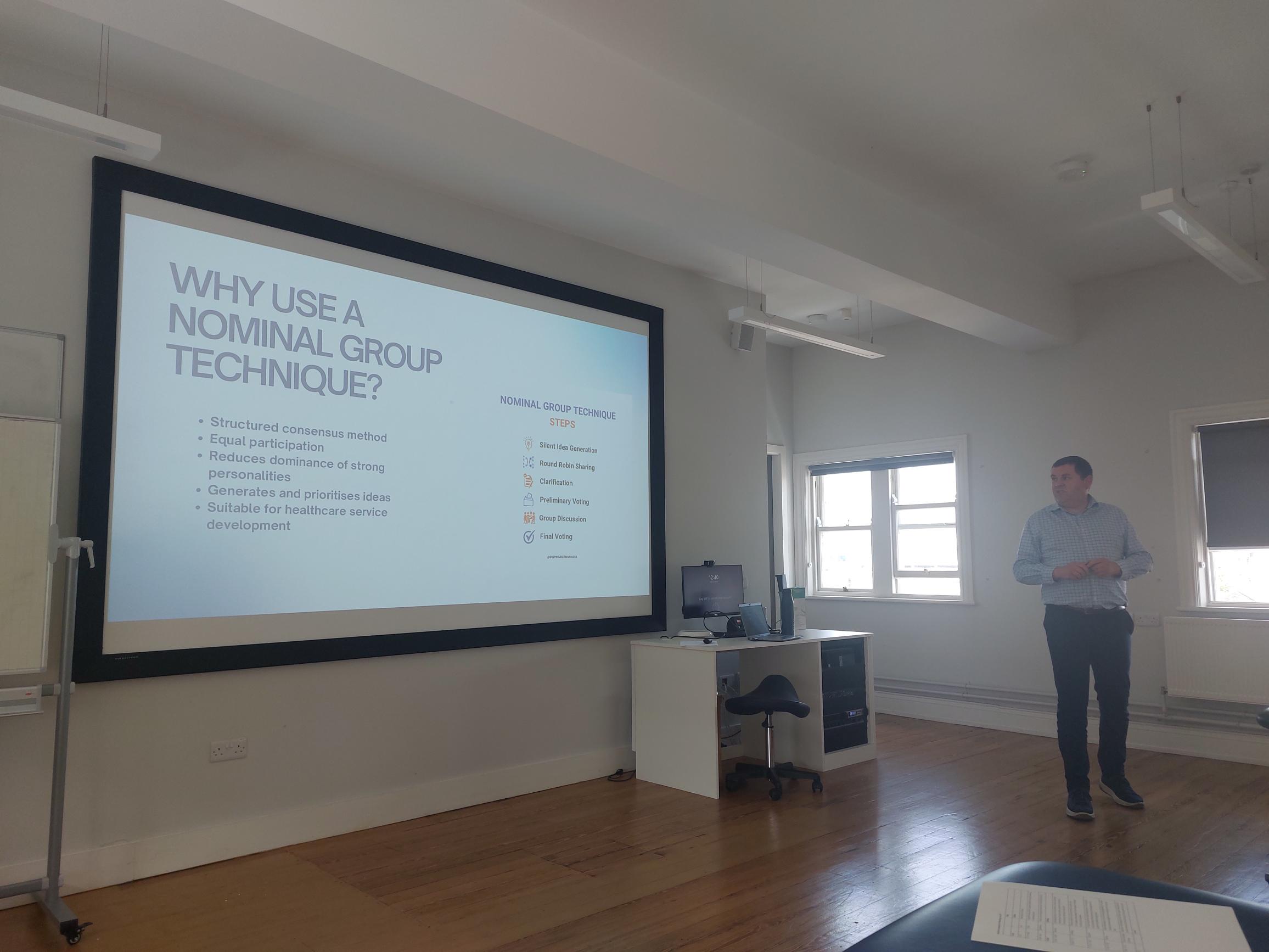 Aidan O'Shea standing infront of a wall where a presentation is being displayed Aidan O'Shea standing infront of a wall where a presentation is being displayed
