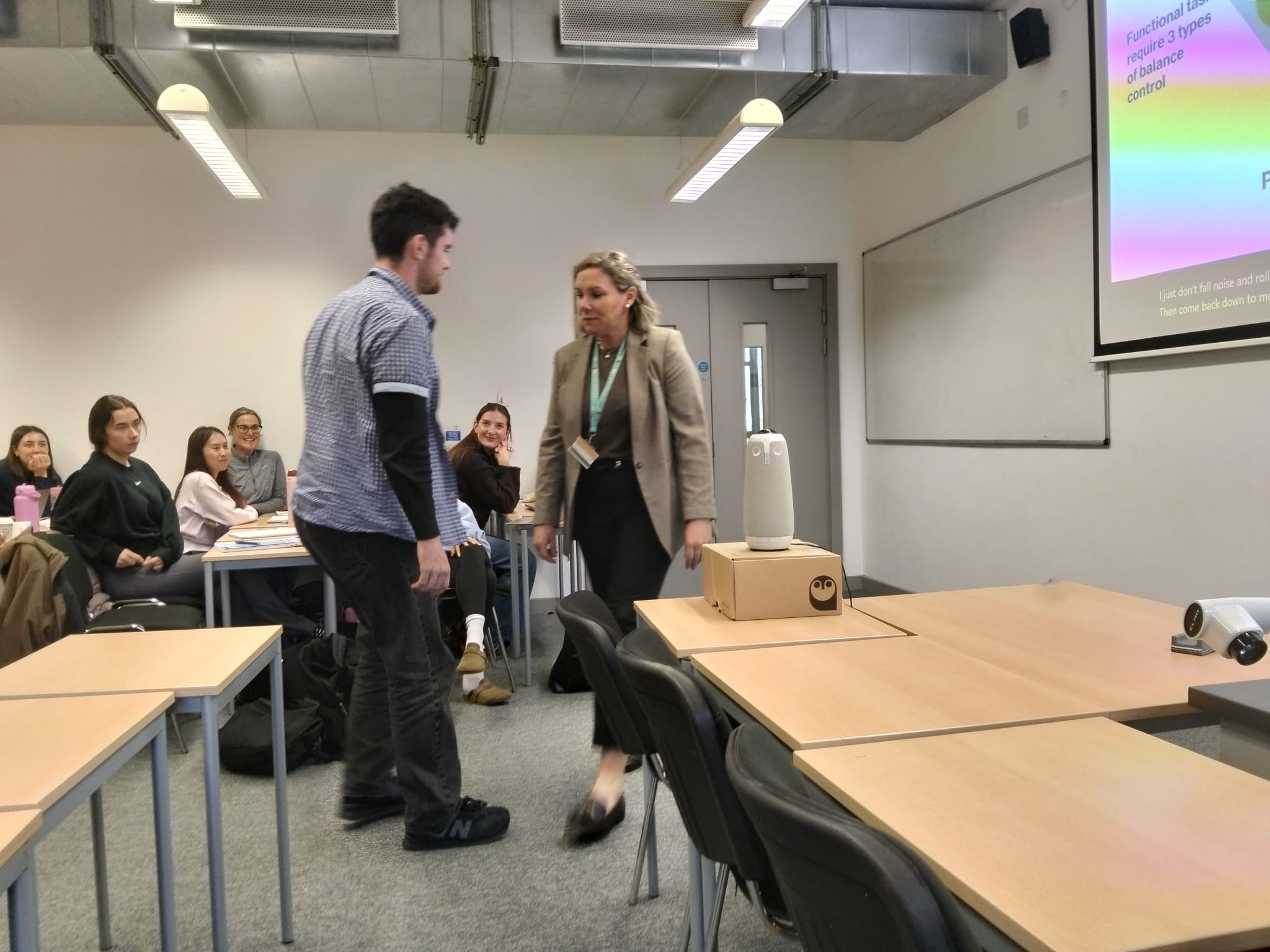 Female lecturer demonstrating infront of a female student Female lecturer demonstrating infront of a female student