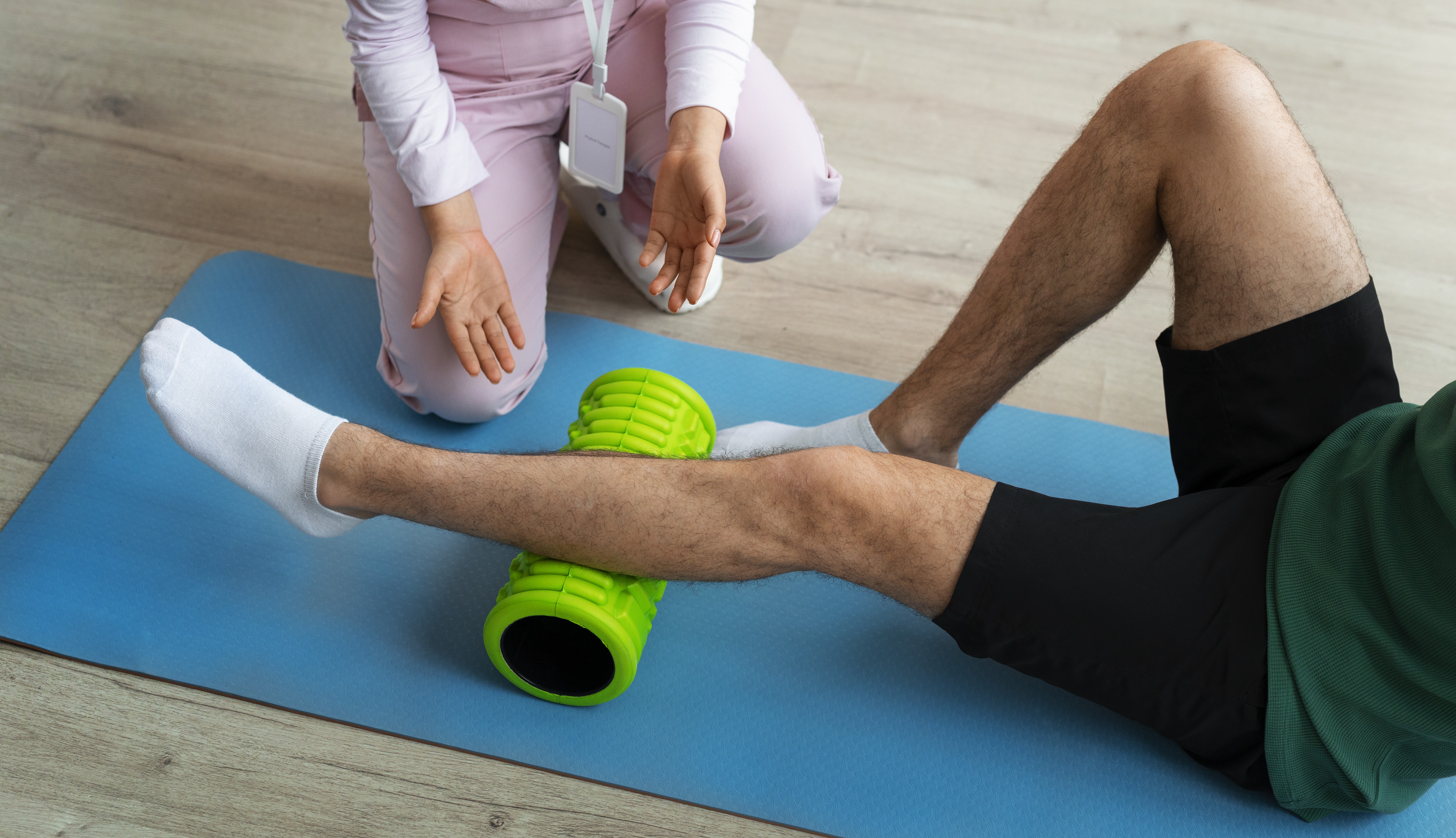 Picture of a physiotherapist helping a patient on a mat
