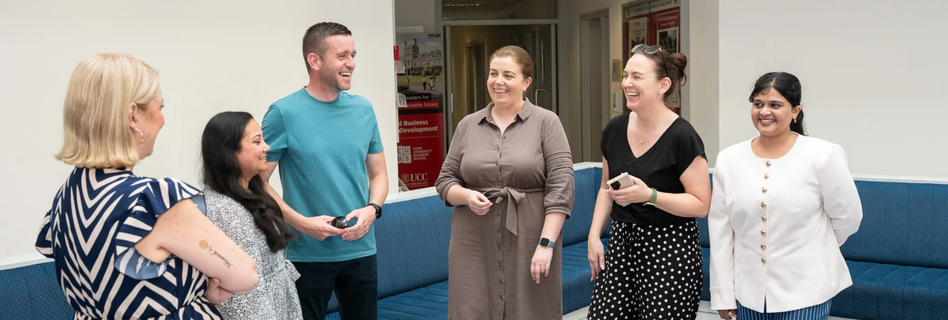 6 people standing and laughing