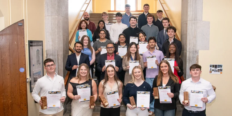 Image of 2 dozen students smiling with awards