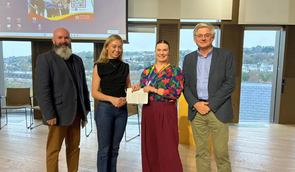 Photo of student smiling and accepting an award