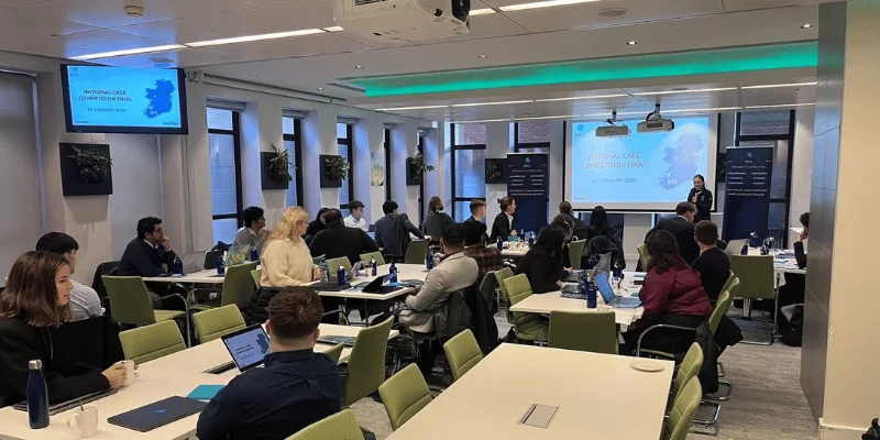 Image of someone presenting to a group of seated students