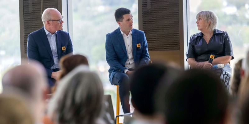Image of 3 people speaking to a crowd