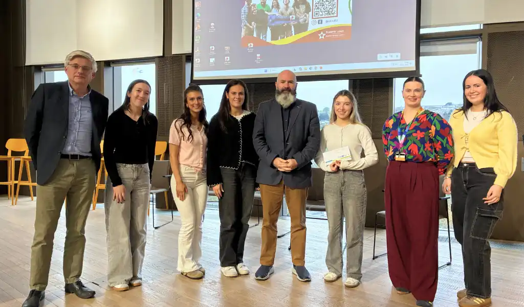 Photo of students smiling and accepting an award Photo of students smiling and accepting an award