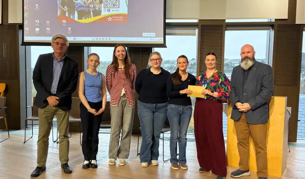 Photo of students smiling and accepting an award Photo of students smiling and accepting an award