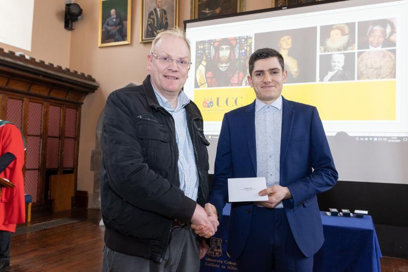 Michael O'Reilly presenting prize to Nicholas Scollard