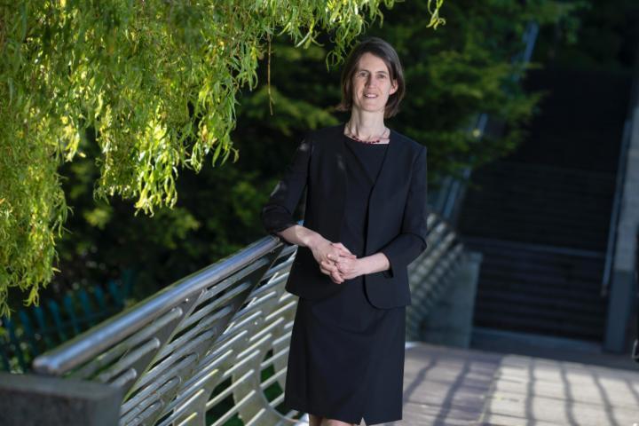 prof roisin connolly standing on a bridge smiling