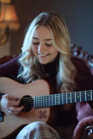 a student playing guitar