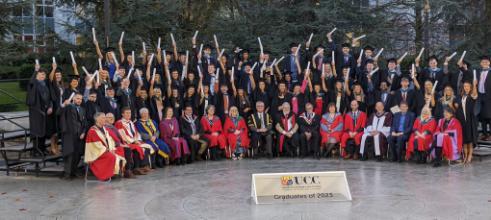 group graduation photo of students and staff on amphitheatre ucc