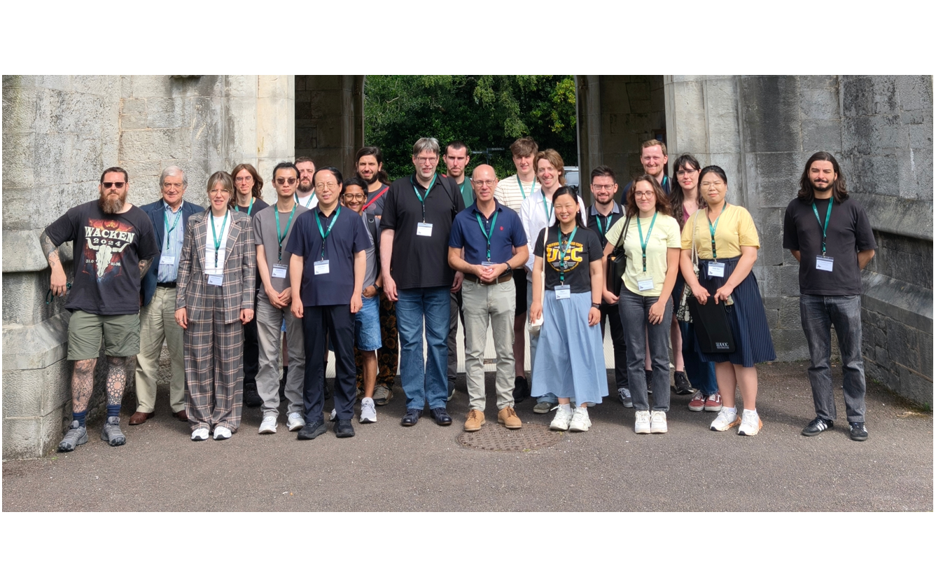 Group photo under stone arch, main quad, UCC