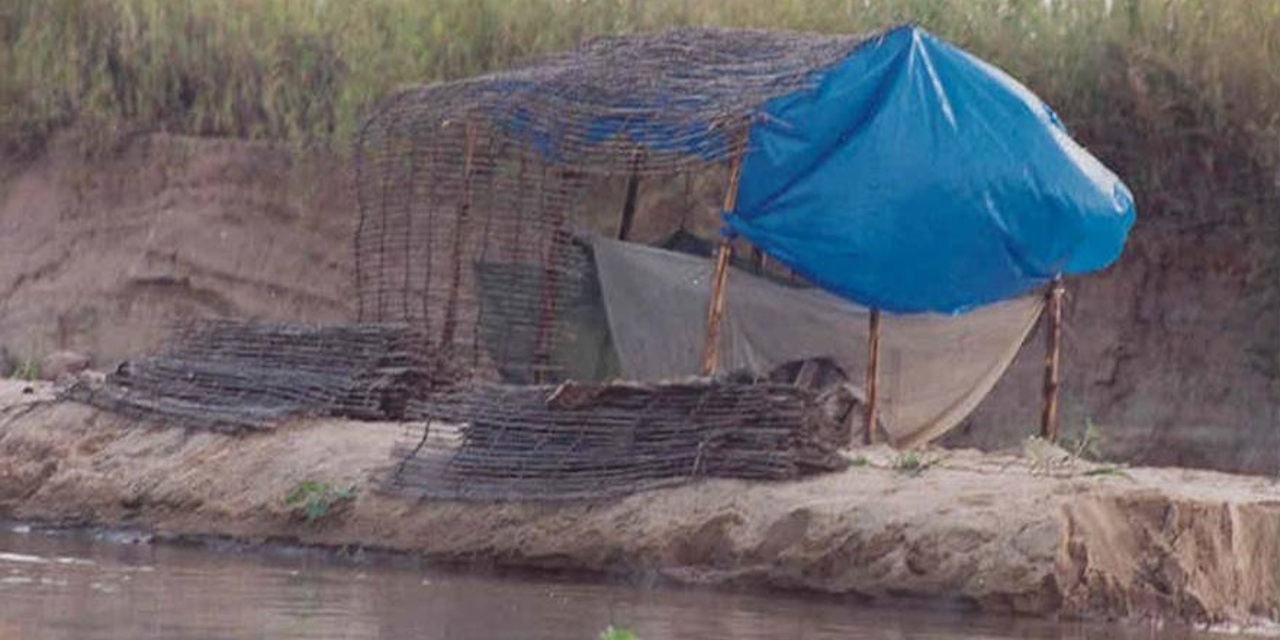 Example of an insecticide treated bednet in circumstances where interacting human and mosquito behaviours may undermine the invaluable protection it otherwise provides against life-threatening malaria infections: A makeshift fisherman’s camp on a sandbank island in the middle of the inland delta of the Kilombero River in southern Tanzania, where malaria exposure rates have been dramatically reduced but used to average about one inoculation per day.