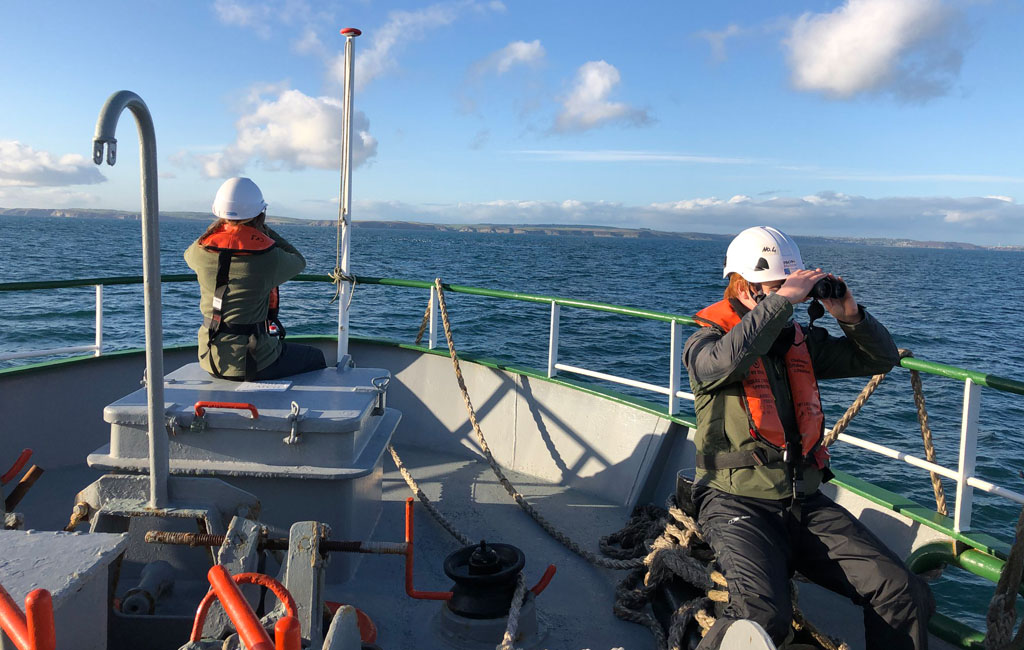 Two students on a boat at sea