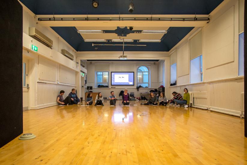 Group of students in a class in the theatre lab