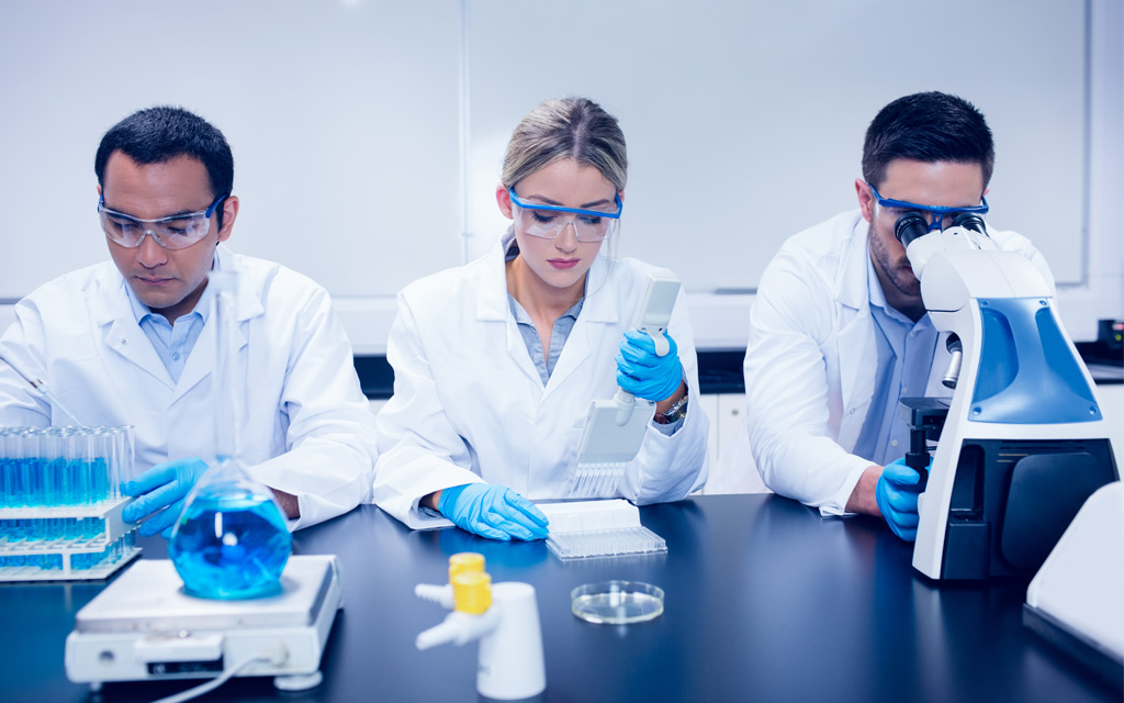 Three STEM students working in a laboratory