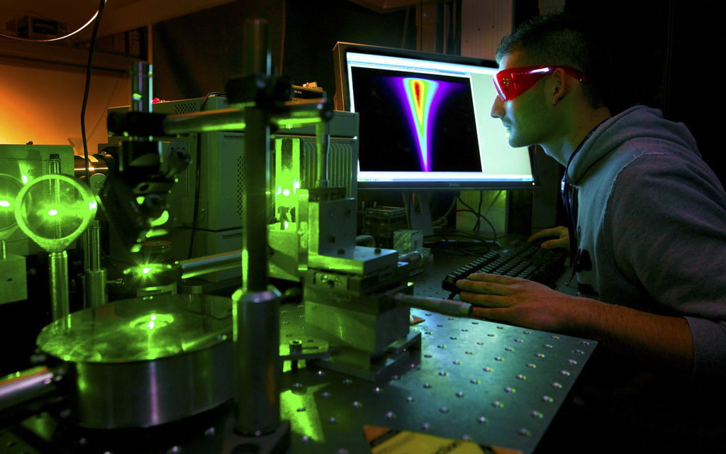 Research student working on a computer in a laboratory