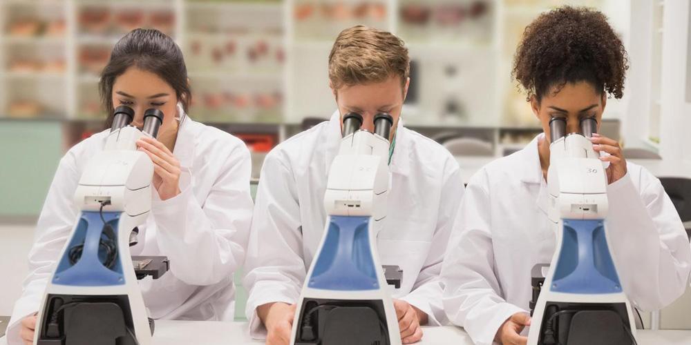 Three students working in a laboratory