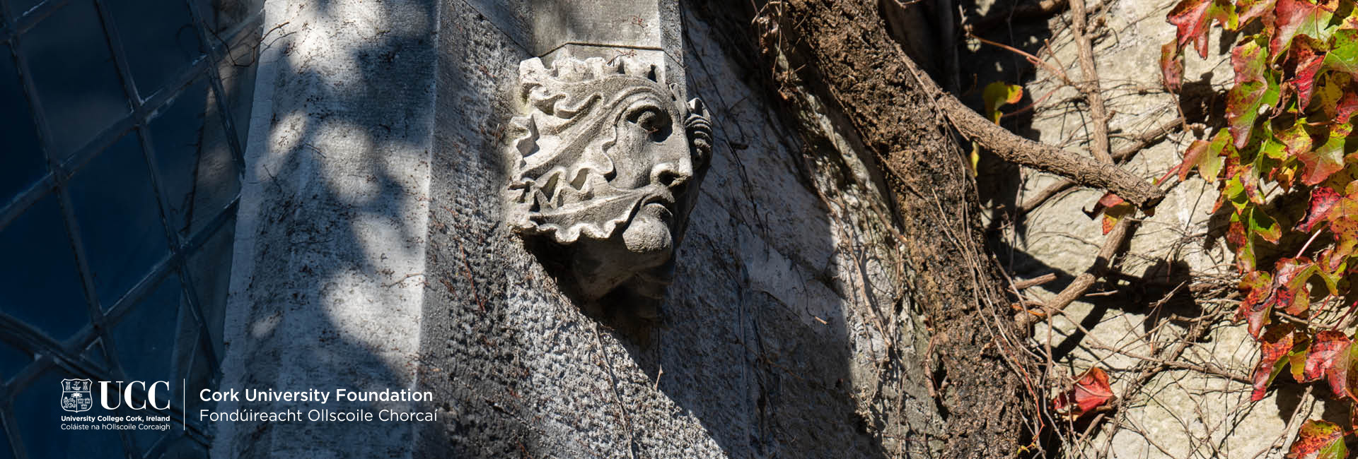 A stone carving of a face over a window at UCC