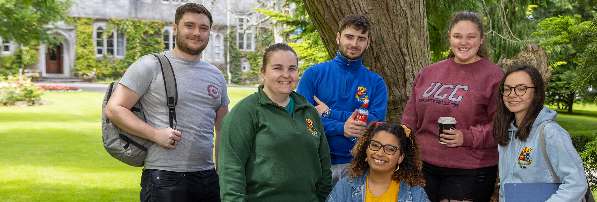 A selection of students smiling on campus