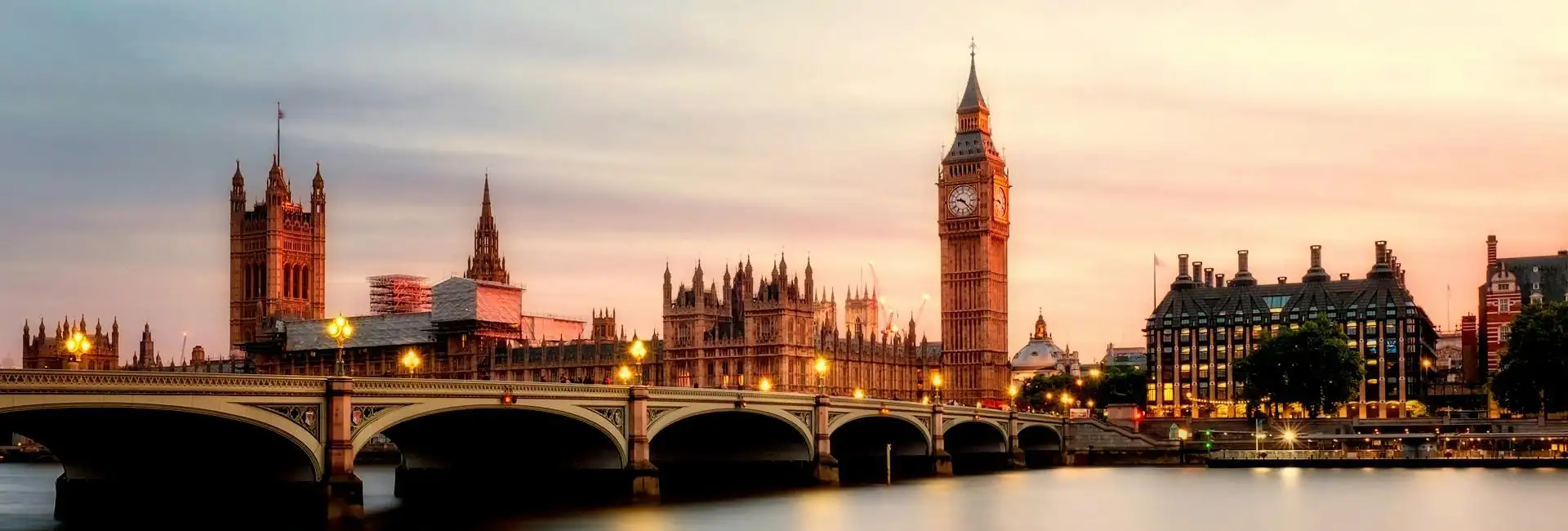 A photo of London tower and parliament at sunset