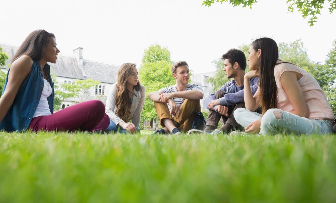 students sit on campus