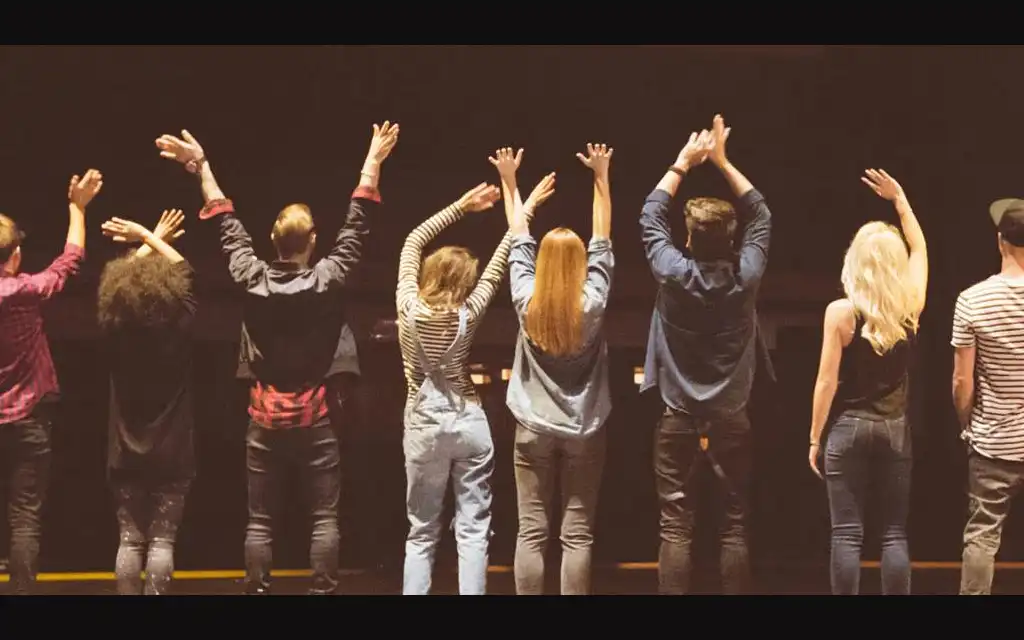 a group of actors taking a bow