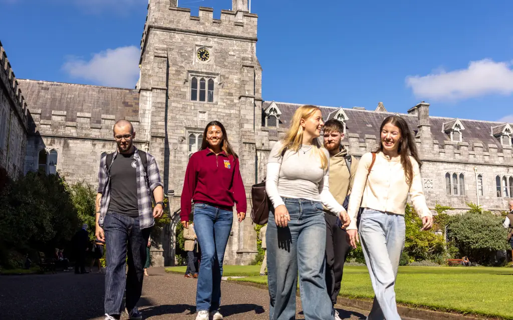 Five students enjoy the main UCC quadrangle on a sunny day