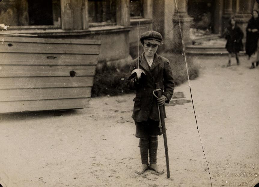 A barefoot boy holds a sword salvaged from Cork City barracks, 1922 NLI HOGW 24
