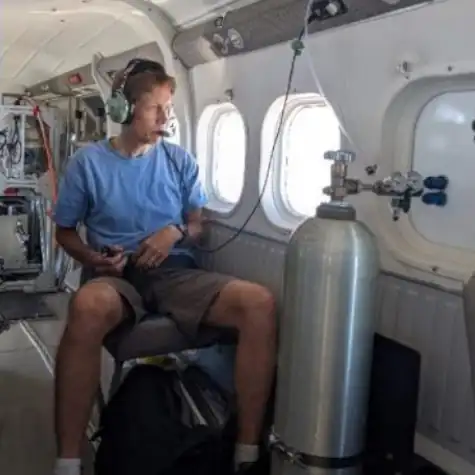 Dr Steven Brown sits in an aeroplane with atmospheric research equipment