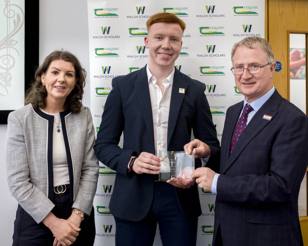 3 people at an awards ceremony. Jack, in the middle, is receiving his award. 3 people at an awards ceremony. Jack, in the middle, is receiving his award.