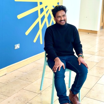 A man sitting on a chair in front of abstract art