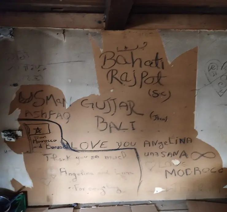 Text covered cardboard against a wall