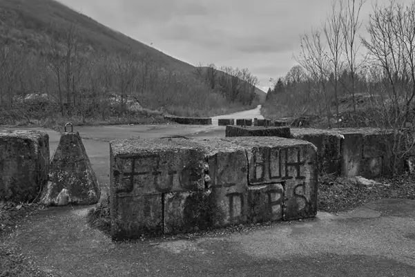 Grey concrete blocks on a road border at Zeljava Airport