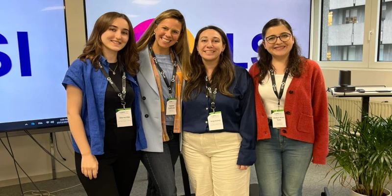 4 young women in brightly coloured clothing grouped together at the ILSI workshop