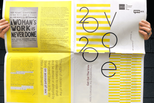 A yellow and white poster catalogue and unfolded held up by a person with only their hands visible